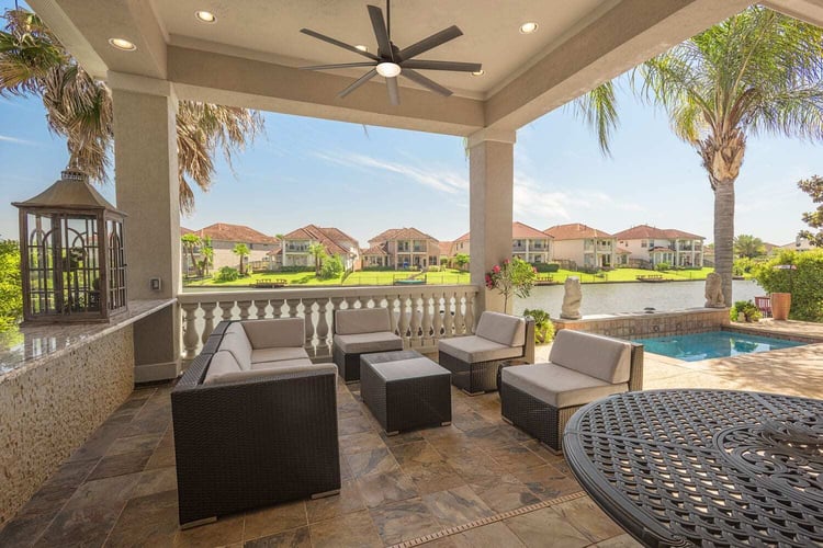 All Star Construction patio renovation in Houston’s Windsor Crest community with covered seating, a pool, and waterfront views.